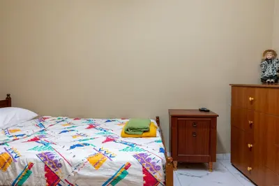 a bedroom with a bed and a wooden dresser at Traditional Stone House in Vouni, Quiet Stay with Courtyard & BBQ in Vouni