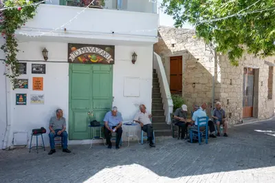a group of people sitting outside of a building at Traditional Stone House in Vouni, Quiet Stay with Courtyard & BBQ in Vouni