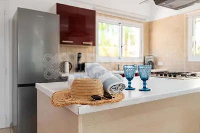 a kitchen with a straw hat and glasses on a counter at Villa Coral in Paralimni