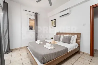 a bedroom with a bed with two towels on it at Villa Coral in Paralimni