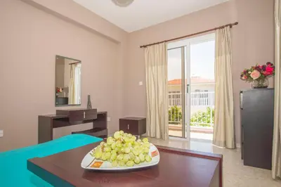 a living room with a plate of grapes on a table at Nissi Maria Villa in Ayia Napa