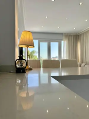 a lamp sitting on a table in a living room at Lumière Retreat 2 in Larnaka