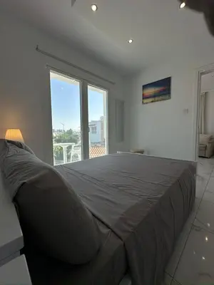 a bedroom with a large bed with a large window at Lumière Retreat 2 in Larnaka