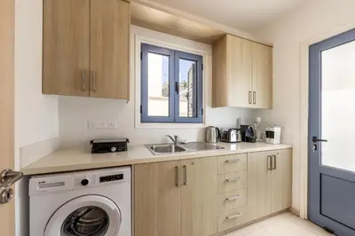 a kitchen with a washing machine and a sink at Protaras Seaside Villa Protamare 32 in Protaras