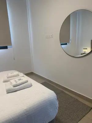 a room with a bed with a mirror on the wall at Kroisou Comfort Stay 2 BEDROOM in Ayios Dhometios