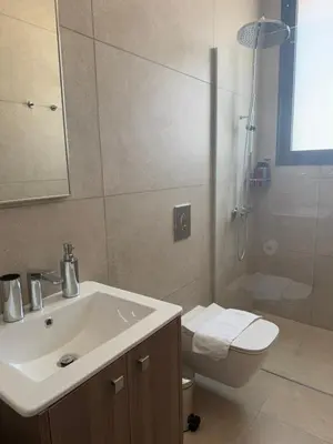 a bathroom with a sink and a toilet and a shower at Kroisou Comfort Stay 2 BEDROOM in Ayios Dhometios