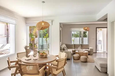 a living room with a table and chairs at SeaSalt Villa in Paralimni