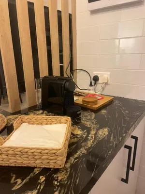 a black counter top with a sewing machine on it at Lazuli Sea View & Pool Studio 303 in Larnaka