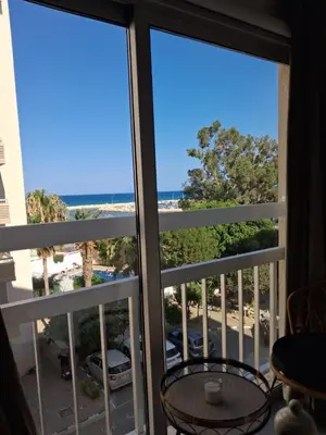 a room with a view of the ocean from a balcony at Lazuli Sea View & Pool Studio 303 in Larnaka