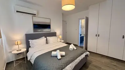 a bedroom with a large bed with two towels on it at Sunrise Villa with Pool by TrulyCyprus in Pervolia