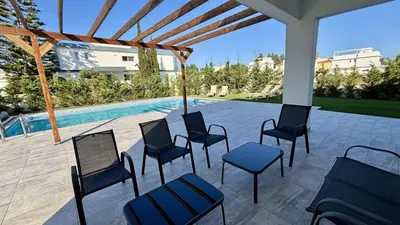 a group of chairs and a swimming pool at Sunrise Villa with Pool by TrulyCyprus in Pervolia