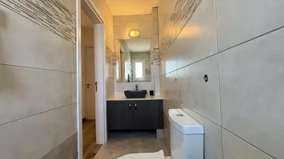 a bathroom with a sink and a toilet at Sunrise Villa with Pool by TrulyCyprus in Pervolia