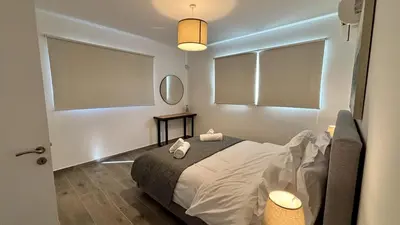 a bedroom with a bed with two white towels on it at Sunrise Villa with Pool by TrulyCyprus in Pervolia