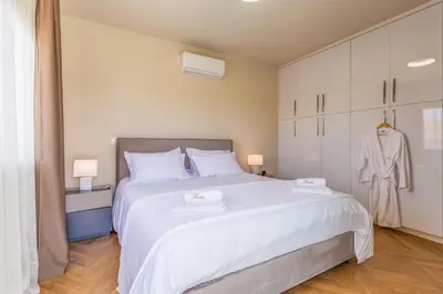 a bedroom with a large white bed with two towels at Pantio Living Villa in Ayia Napa