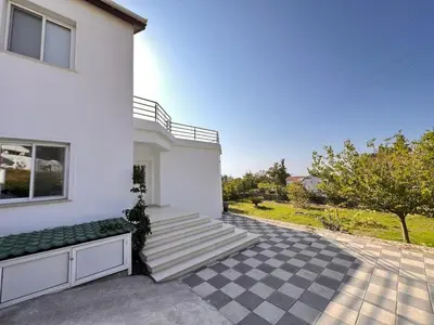 a white house with steps leading up to it at Villa Large Garden&Outdoor Space in Lageia