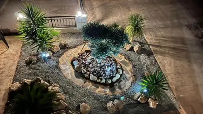 an overhead view of a garden with palm trees and lights at Villa Porta Aurea in Ayia Napa