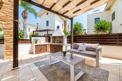 a patio with a couch and a stove at Villa Enaria Serene 3Bdr Retreat in Ayia Thekla in Ayia Napa