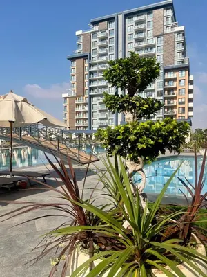 a large apartment building with a pool in front of it at Riverside Life Residence in İskele