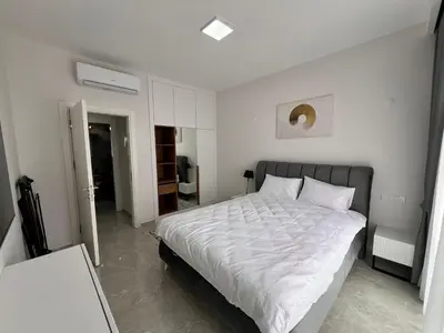 a bedroom with a large bed with white sheets at Riverside Life Residence in İskele