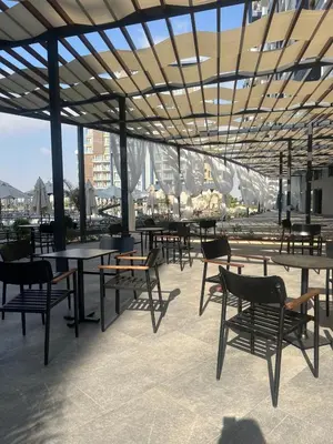 a group of tables and chairs under a pavilion at Riverside Life Residence in İskele