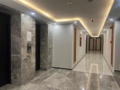a hallway of a building with a tile floor at Riverside Life Residence in İskele