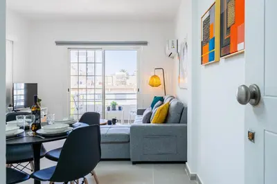 a living room with a couch and a table at Destiny 1-Bedroom Apartment in Larnaka