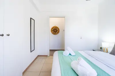a bedroom with a bed with towels on it at Destiny 1-Bedroom Apartment in Larnaka