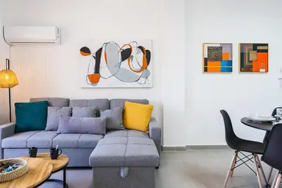 a living room with a couch and a table at Destiny 1-Bedroom Apartment in Larnaka