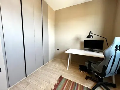 an office with a desk and a chair and a computer at STAY Mouson View Apartment in Limassol