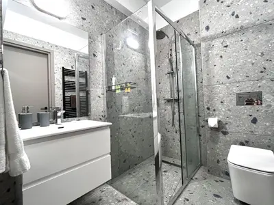 a bathroom with a shower and a sink and a toilet at STAY Mouson View Apartment in Limassol