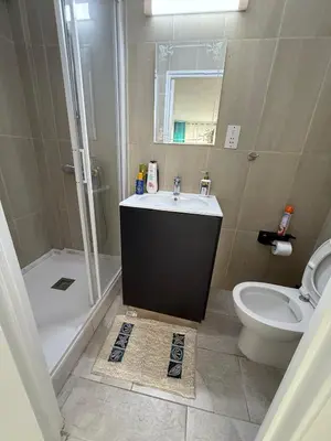 a bathroom with a sink and a shower and a toilet at Kypa rooms 50 steps to the beach in Larnaka