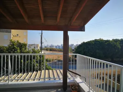 a balcony with a white railing and a view of a street at Apartment Sun Kapparis in Paralimni
