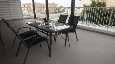 a table and chairs sitting on a balcony at Apartment Sun Kapparis in Paralimni