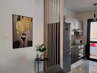 a kitchen with a painting of a woman on the wall at Lama's Residence in Nicosia