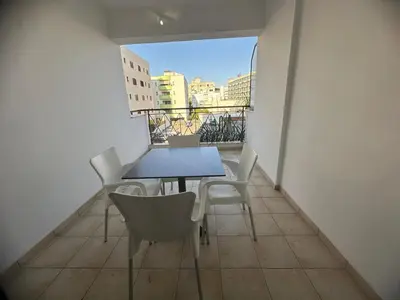 a table and chairs on a balcony with a view at Lama's Residence in Nicosia