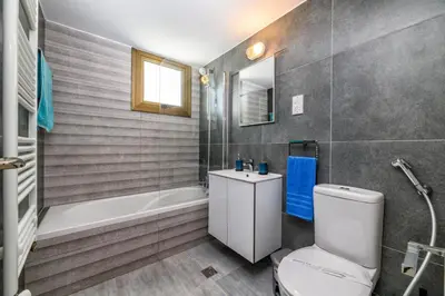 a bathroom with a toilet and a tub and a sink at Kymma Seaview #24 in Ayia Napa