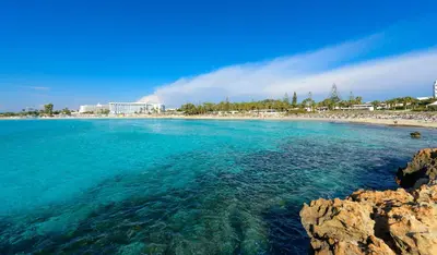 a view of a beach with a resort in the background at Kymma Seaview #24 in Ayia Napa