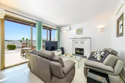 a living room with two chairs and a television at Kymma Seaview #24 in Ayia Napa