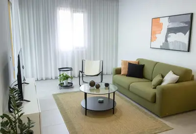 a living room with a couch and a table at Stylish Modern City Center Stay in Nicosia