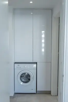 a washing machine in a room with a white wall at Stylish Modern City Center Stay in Nicosia