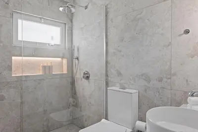a bathroom with a shower and a toilet and a sink at Themelio Living 2-Bed Apartment Nicosia City Centre in Nicosia