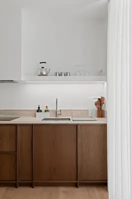 a kitchen with wooden cabinets and a sink at Themelio Living 2-Bed Apartment Nicosia City Centre in Nicosia