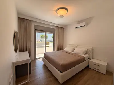a bedroom with a bed and a large window at Luxury Limassol Seaside Pool Suite in Limassol