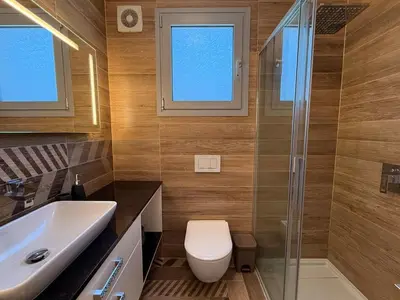 a bathroom with a toilet and a sink and a shower at Luxury Limassol Seaside Pool Suite in Limassol