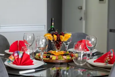 a table with a bottle of wine and wine glasses at AURA Apt Modern 1BR in Central Limassol and Free Parking in Limassol