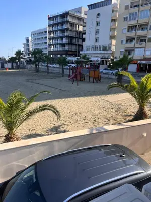 a car parked next to a beach with palm trees at Sandy Kisses in Larnaka