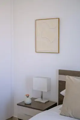 a bedroom with a bed with a lamp on a table at Chic & Elegant Hideaway - Your Luxury Escape in Livadhia