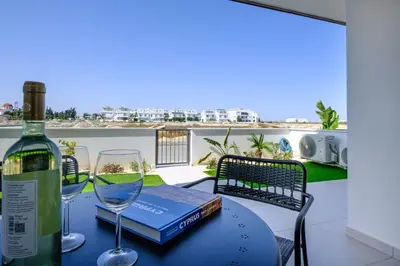 a table with a bottle of wine and two glasses at Chic & Elegant Hideaway - Your Luxury Escape in Livadhia
