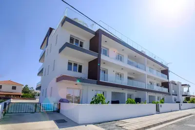 an apartment building with balconies on a street at Chic & Elegant Hideaway - Your Luxury Escape in Livadhia
