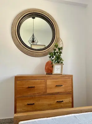 a mirror on top of a dresser in a room at Teak Charm in Larnaka